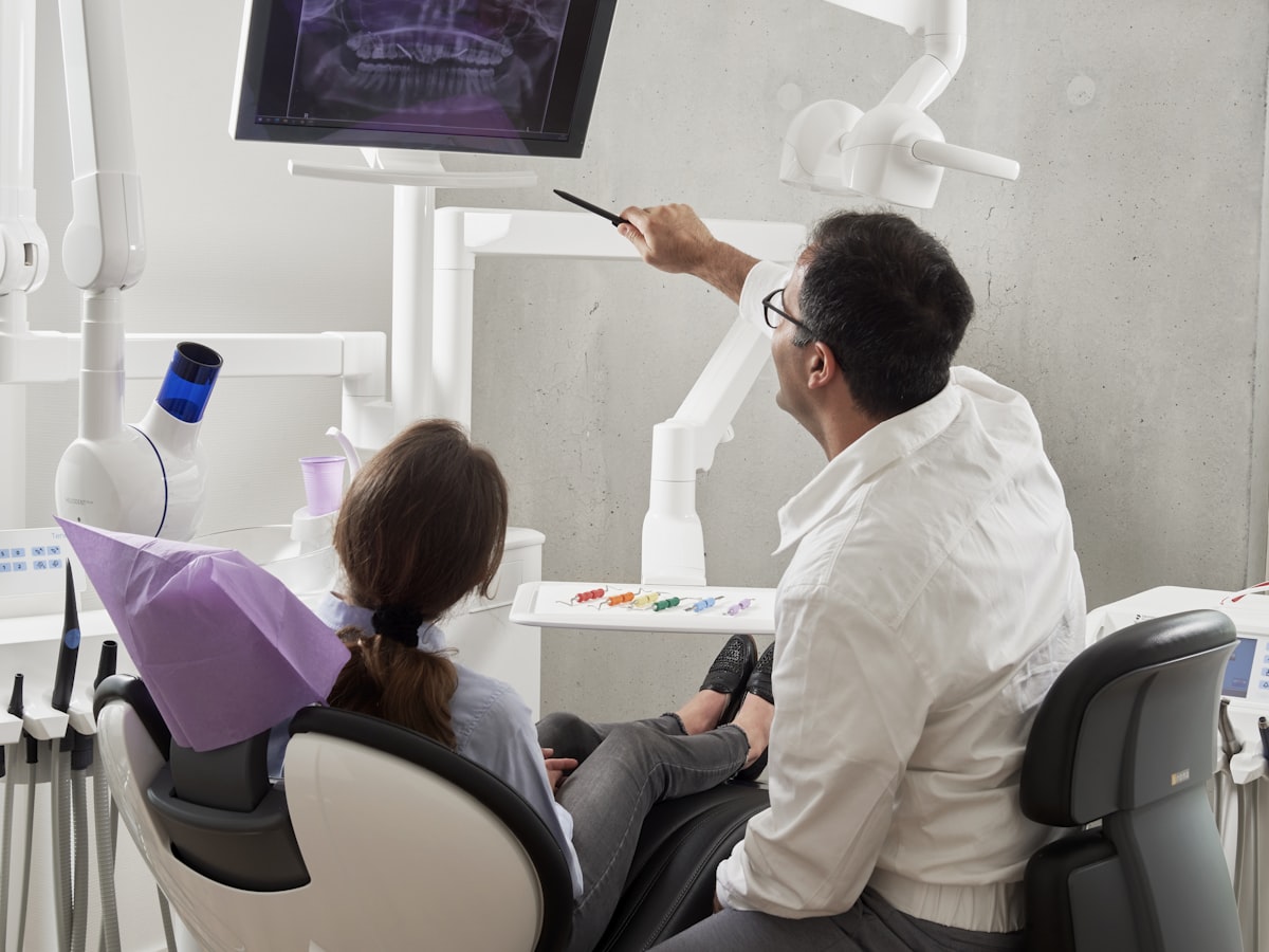 Dental hygienist preparing instruments in a modern treatment room